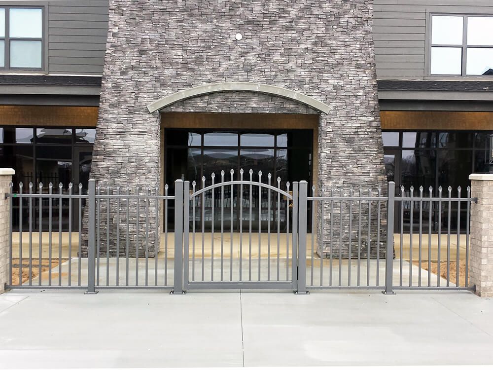 A large brick building with a metal gate in front of it.