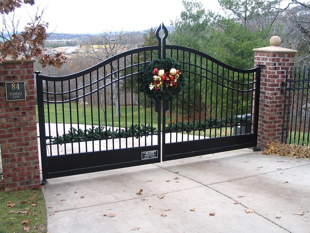 A black gate with a christmas wreath on it | Best fencing springfield mo
