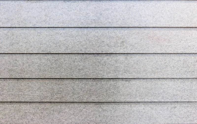 Close-up of a light gray, horizontally ridged surface with thin dark lines.