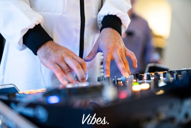 Close-up of a Vibes DJ mixing music at a corporate awards event.