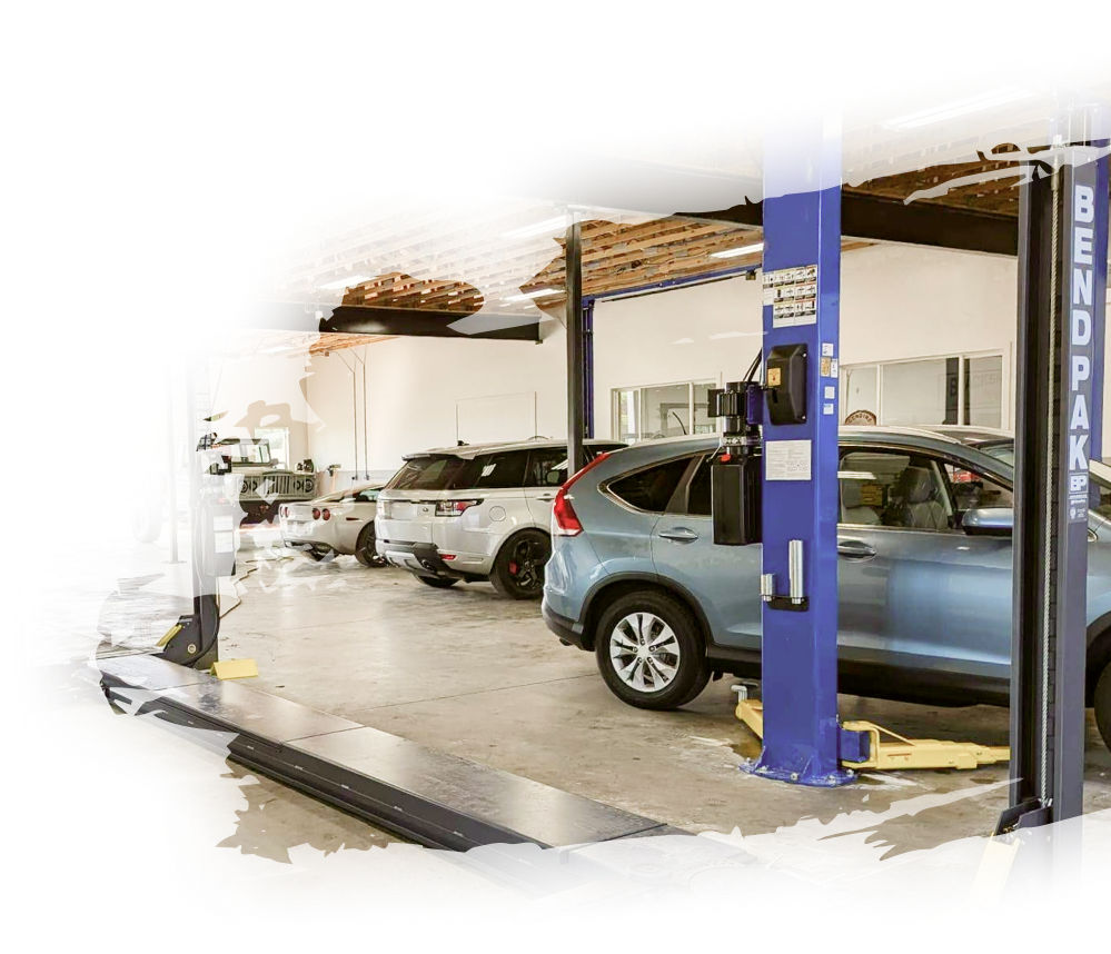 A car is sitting on a lift in a garage. | Eden Automotive Repair