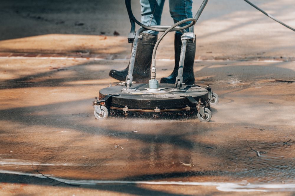 Pressure washer cleaning a dirty concrete floor, spraying water and foam