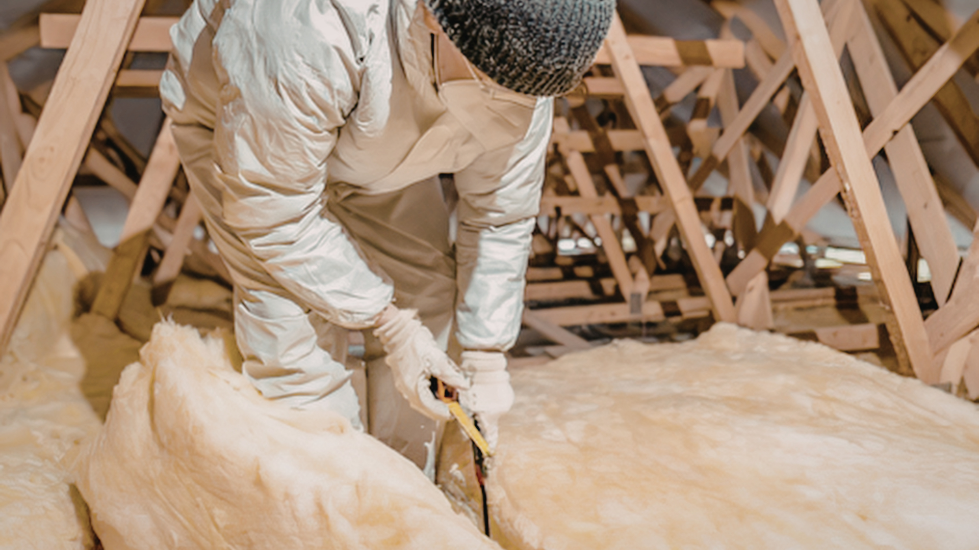Crew applying spray foam to seal roof air leaks and gaps