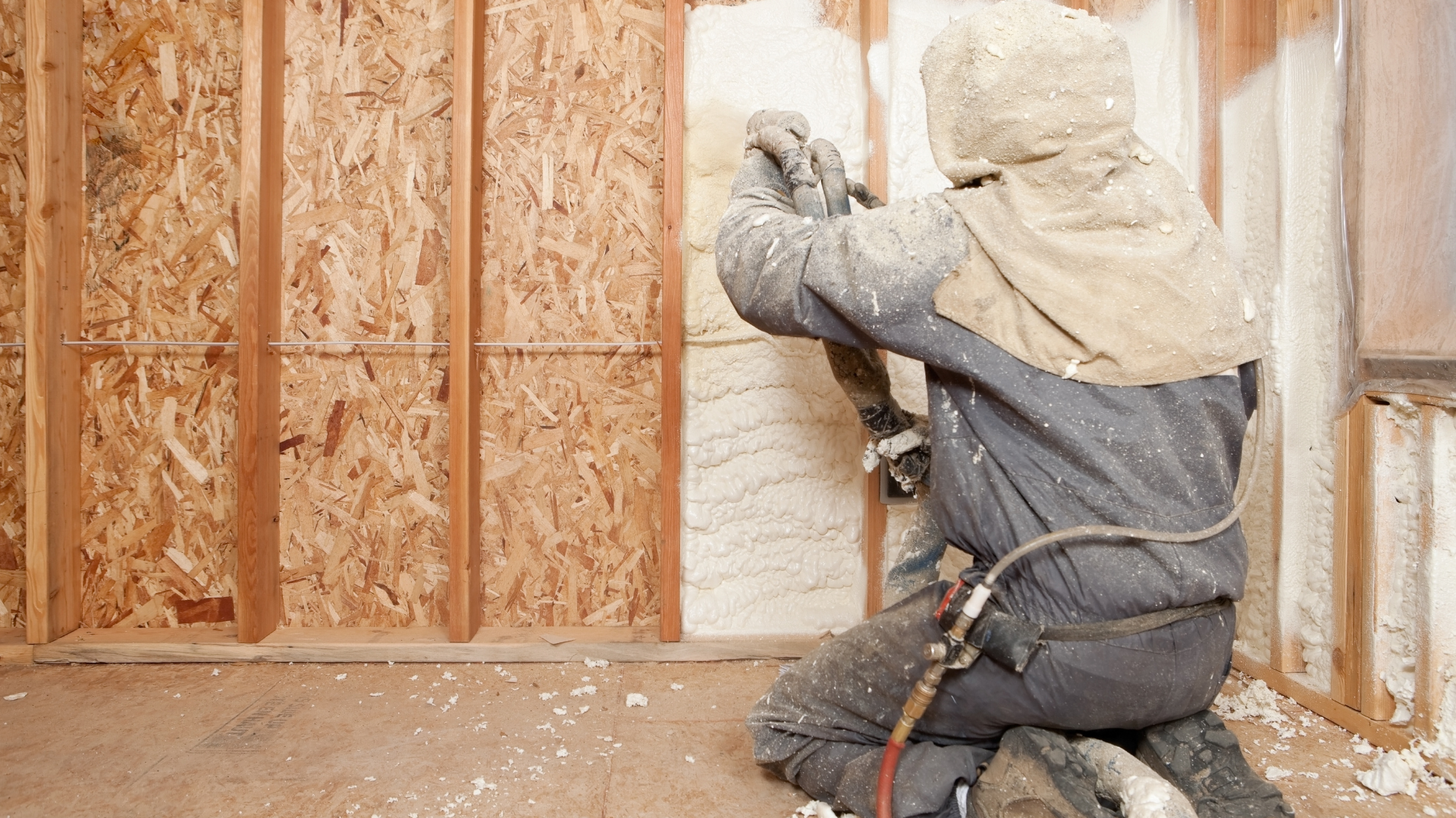 Technicians applying insulation to reduce moisture issues in crawlspace