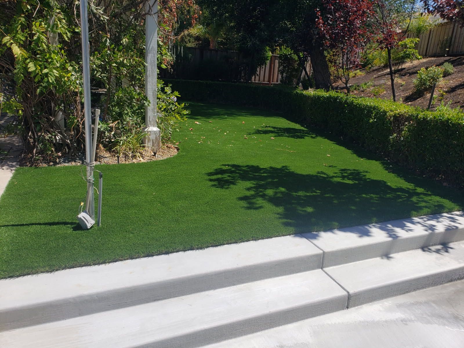A Lawn With a Flag Pole in the Middle of It and Steps Leading Up to It
