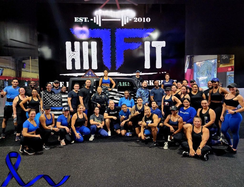 A group of people are posing for a picture in front of a sign that says hi fit