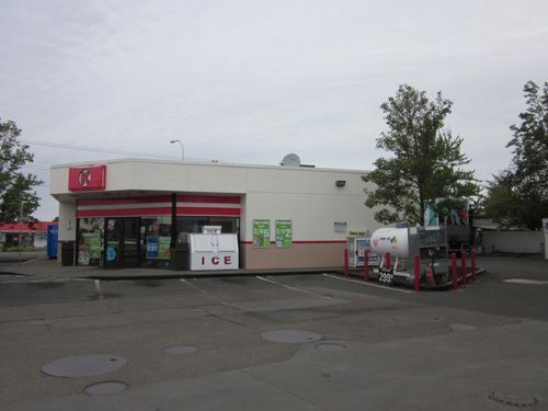A gas station with a propane tank in front of it