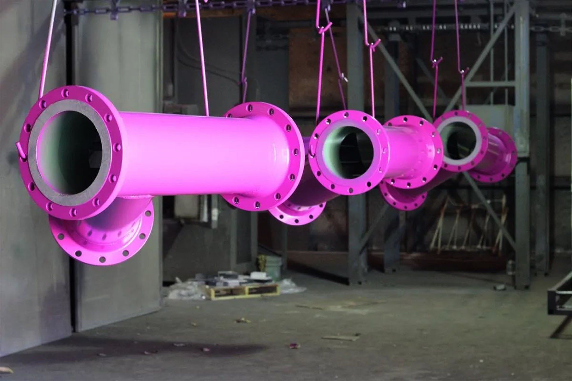 Large Powder Coated Components Hanging From Hooks