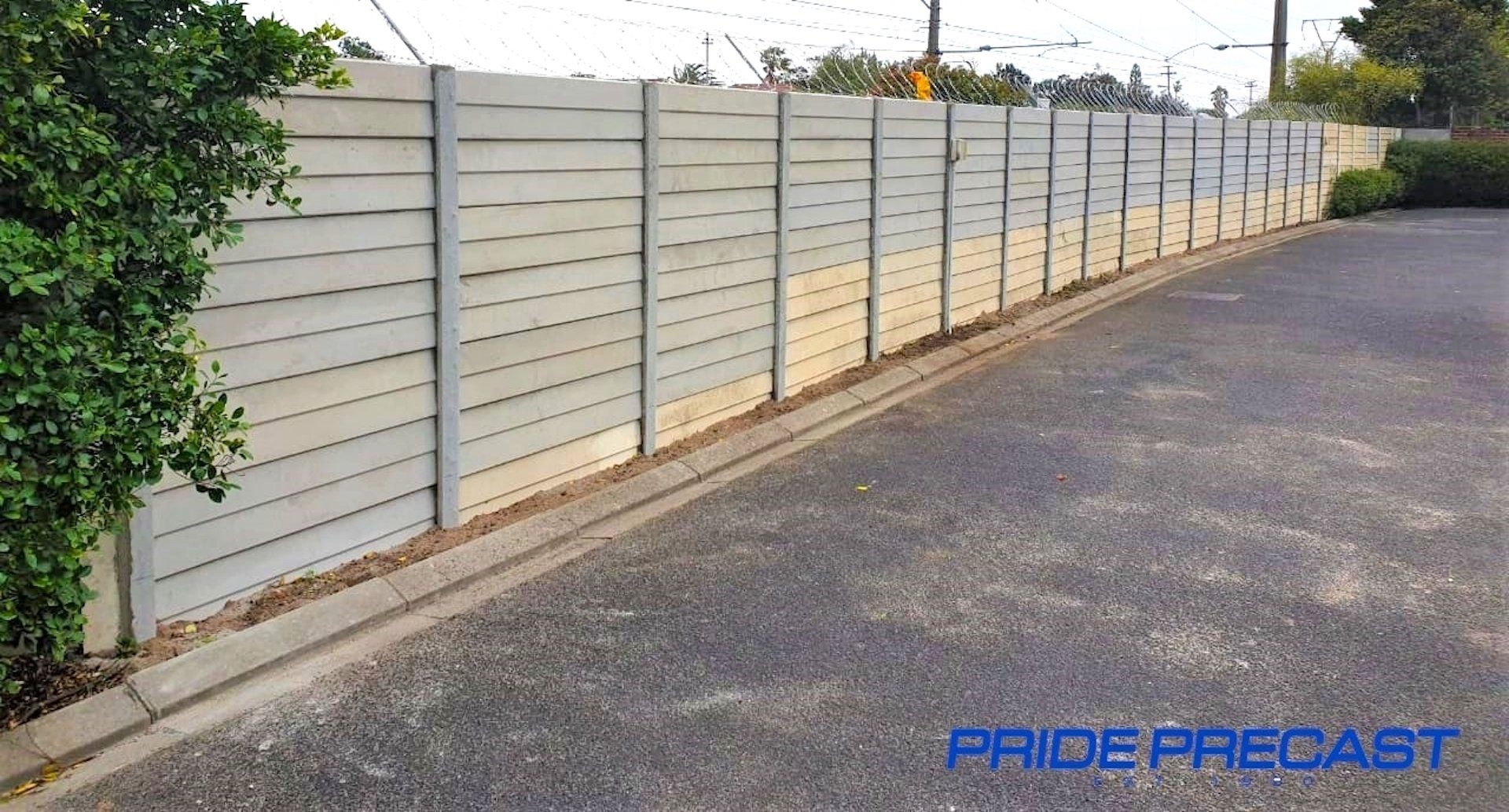 A picture of a fence with pride precast written on the bottom