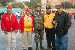 Five men pose outdoors; veterans in uniform and jackets.