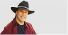 Man with a black hat and red jacket smiles.