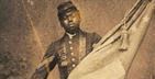 Black soldier holding a flag, wearing a uniform.