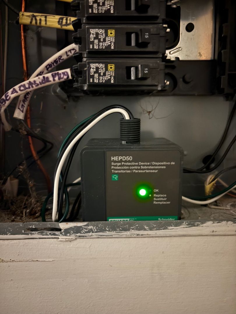 Green HP modular power supply inside an open electrical panel with wires and switches.