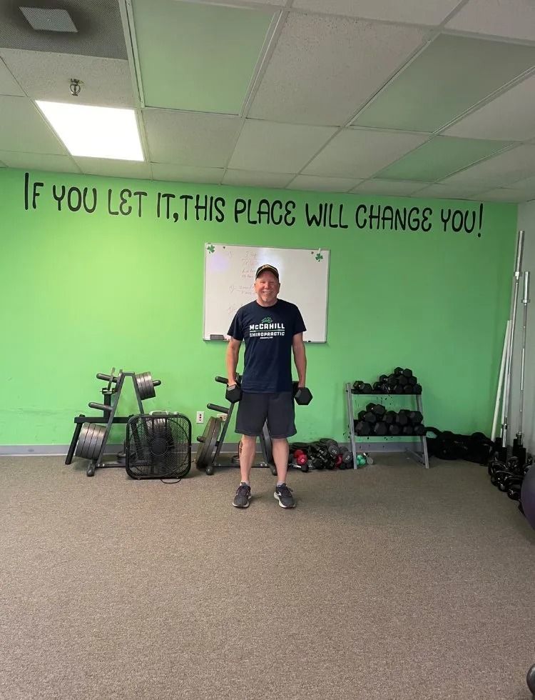A man is standing in a gym.