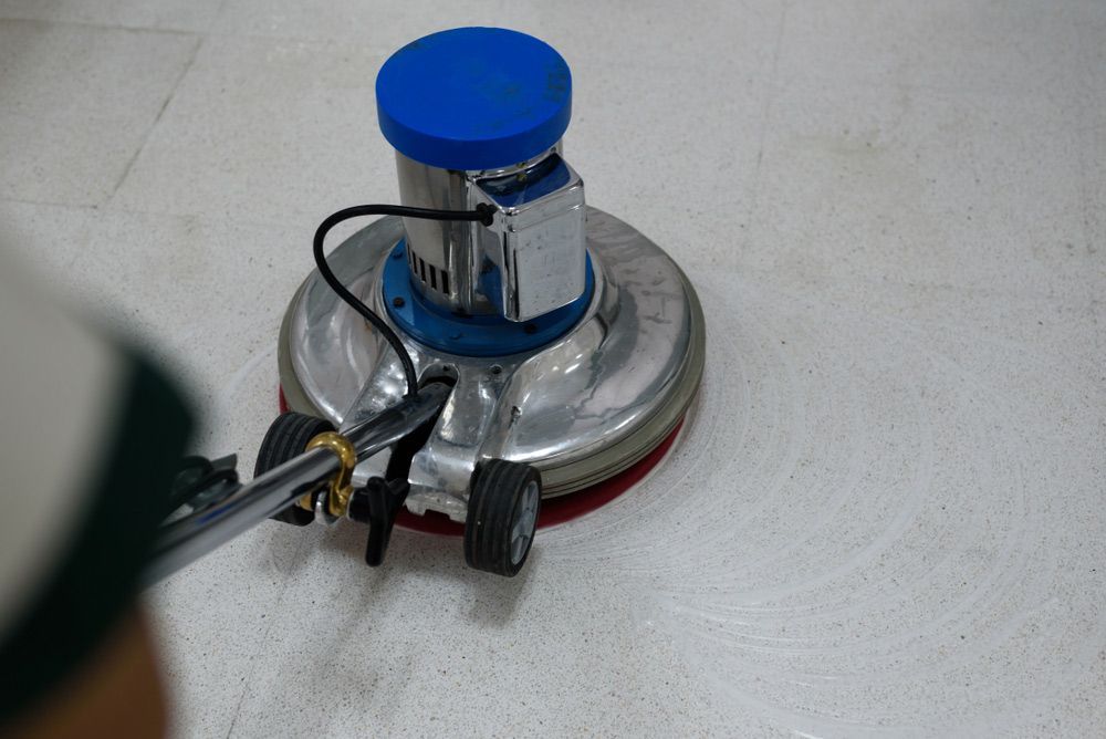 A Person Is Using a Machine to Clean a Tile Floor — North Coast Commercial Cleaners In Bli Bli, QLD