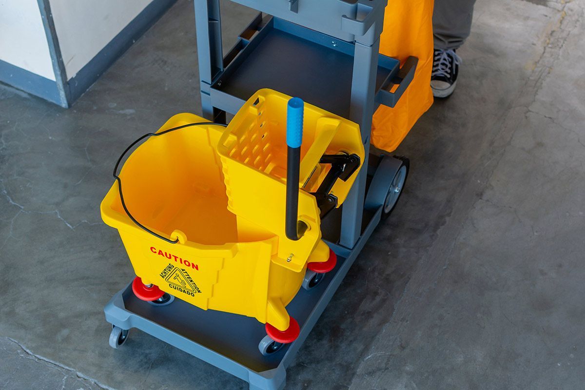 A Yellow Mop Bucket Is Sitting on Top of A Cleaning Cart — North Coast Commercial Cleaners In Bli Bli, QLD