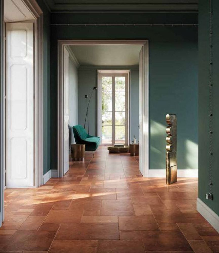 A Hallway With A Wooden Floor And Green Walls Leading To A Living Room — Corrimal Ceramic Tiles Pty Ltd in Corrimal, NSW