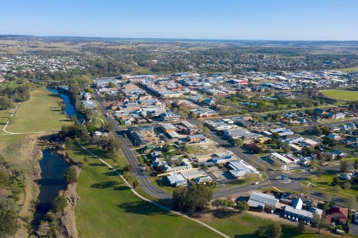An Aerial View of a Small Town With a River Running Through It — Corrimal Ceramic Tiles Pty Ltd in Dapto, NSW