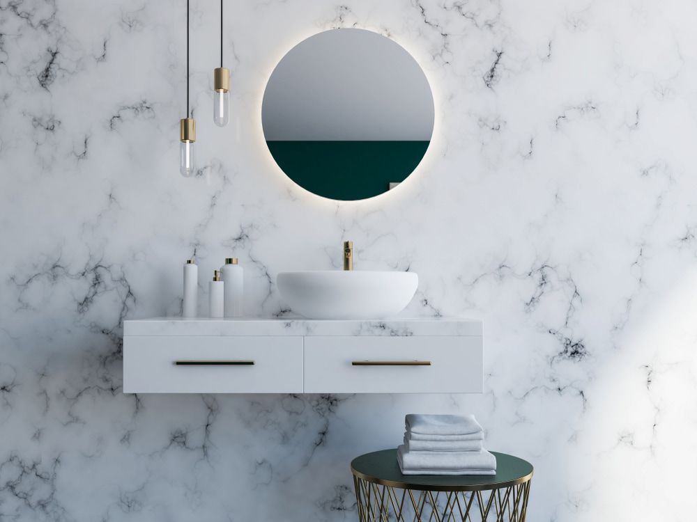 A Bathroom With A Sink, Mirror And Marble Wall — Corrimal Ceramic Tiles Pty Ltd in Bowral, NSW