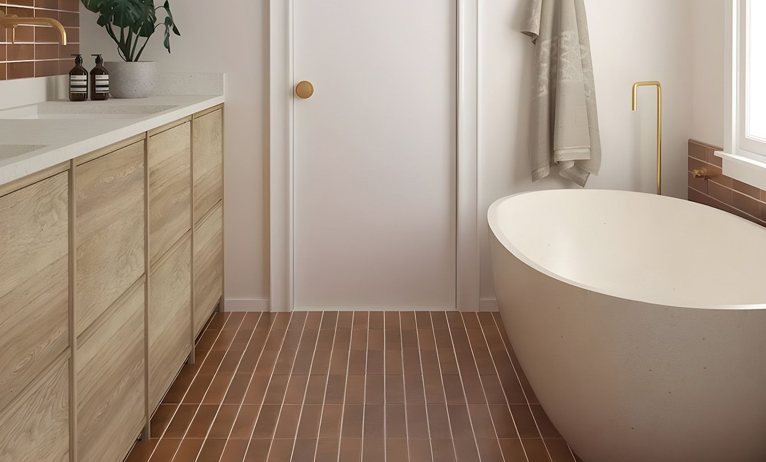 Bathroom With Brown Tile Floor And Accent Wall