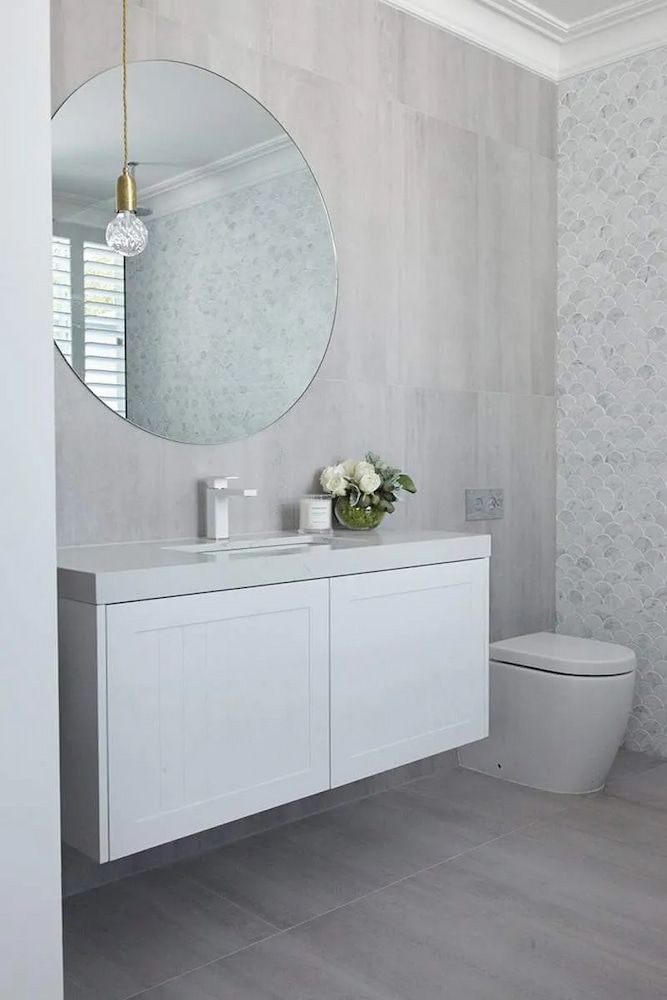 A Bathroom With A Sink, Toilet And Mirror — Corrimal Ceramic Tiles Pty Ltd in Kiama, NSW