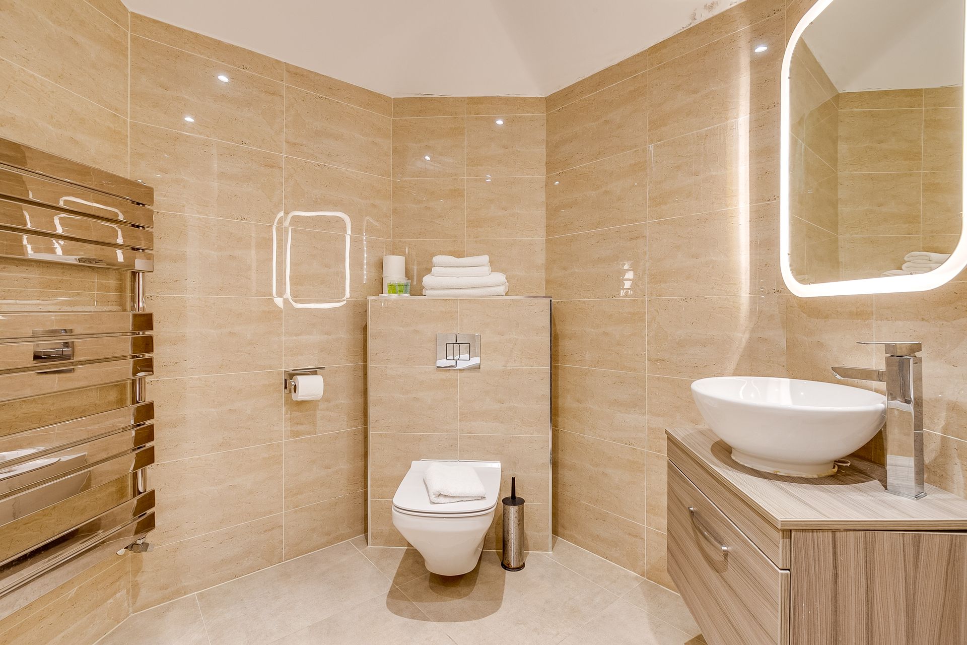 A bathroom with a toilet , sink and mirror.