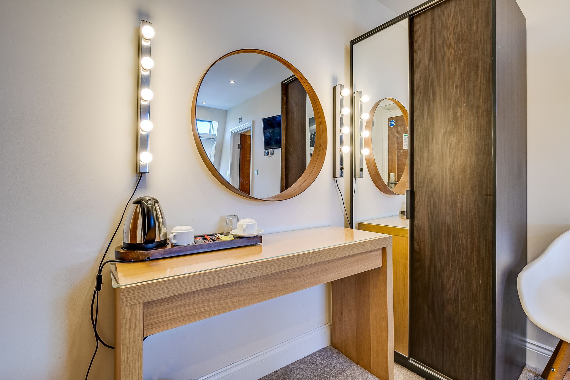 There is a table with a mirror on it in the room.