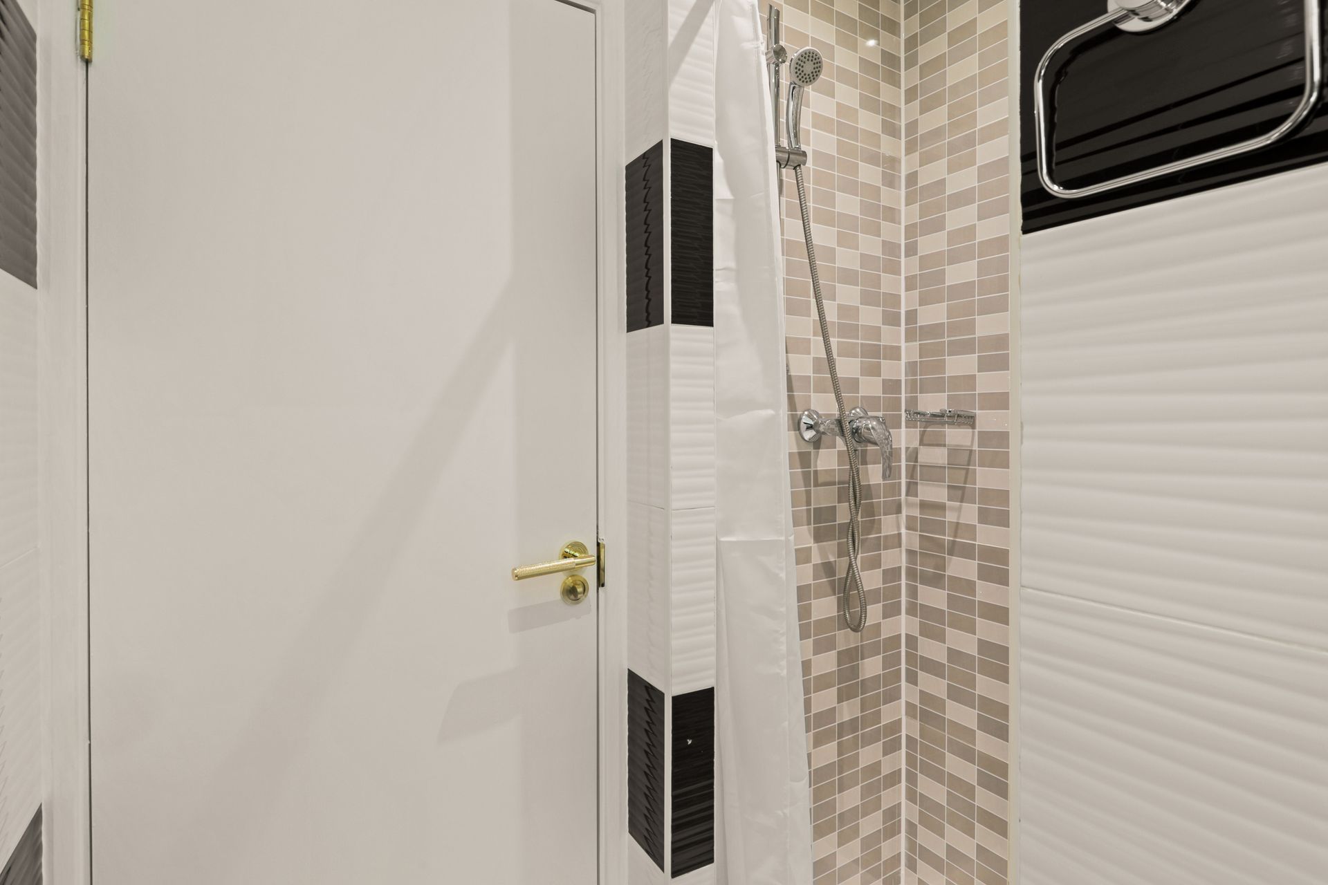A bathroom with a shower and a door.