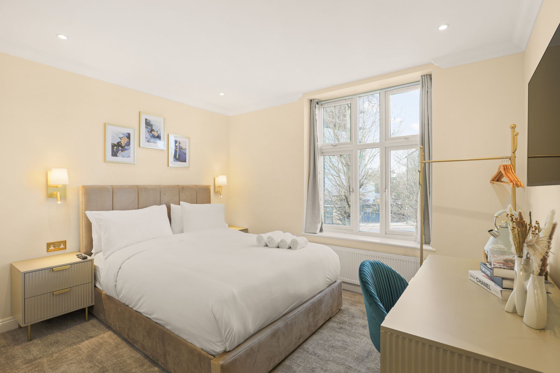 A bedroom with a king size bed and a desk.