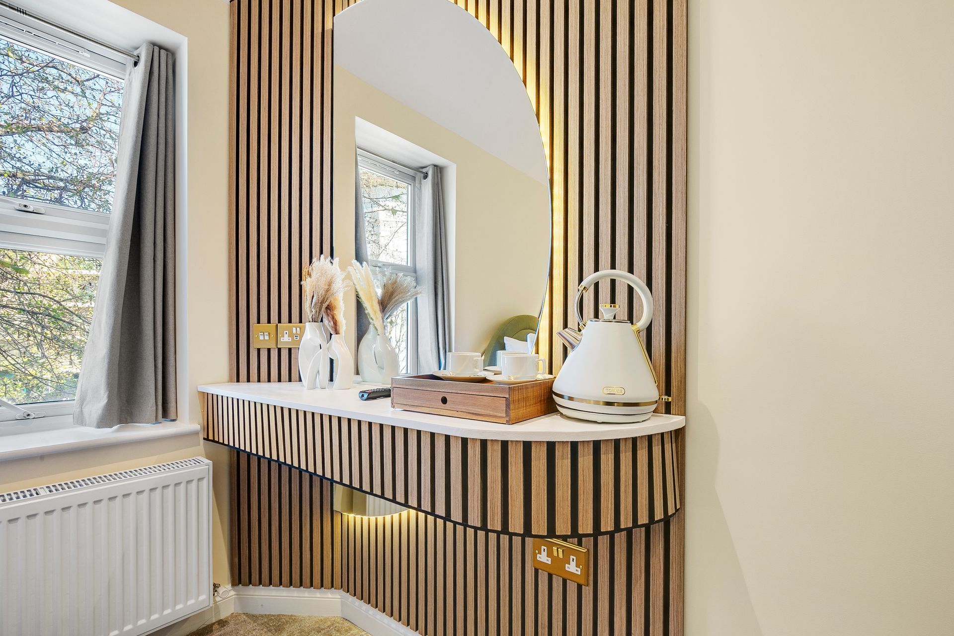 A bathroom with a wooden wall and a large mirror.