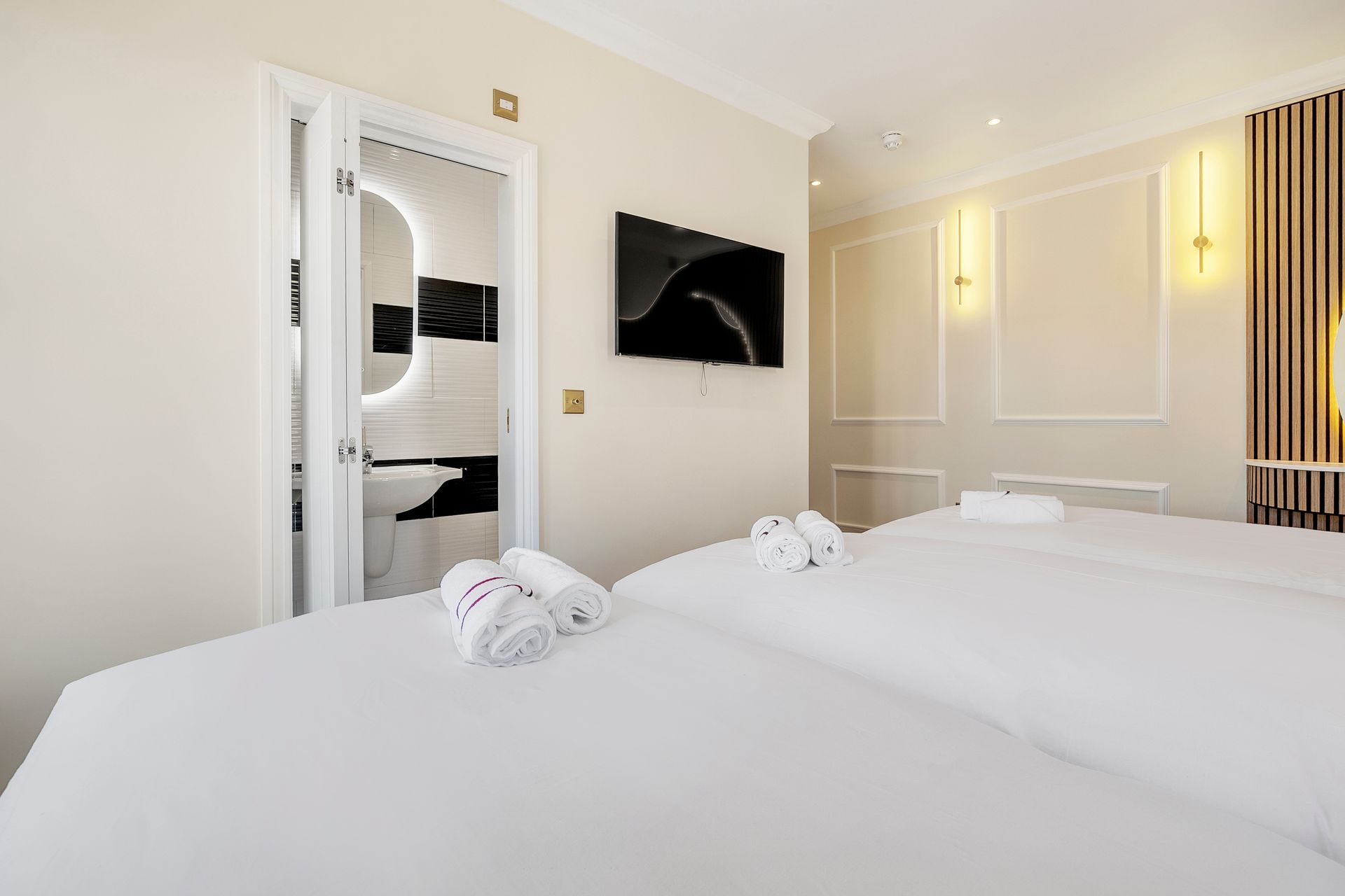 A hotel room with a bed , television , and bathroom.