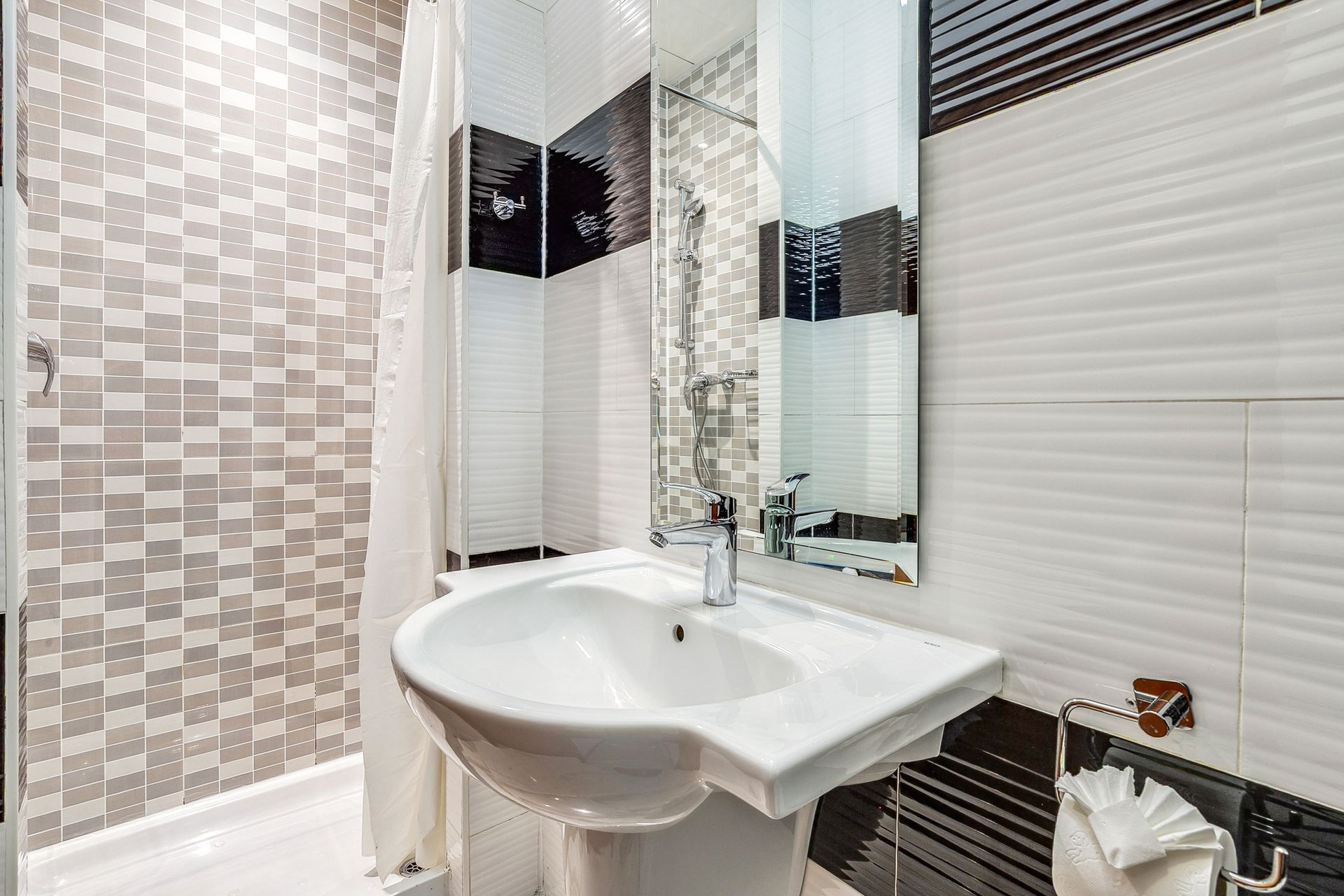 A bathroom with a sink , mirror and shower curtain.