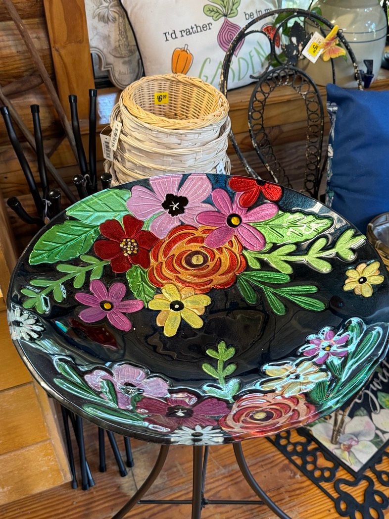 Floral-painted glass table with colorful flowers and leaves in a home decor setting