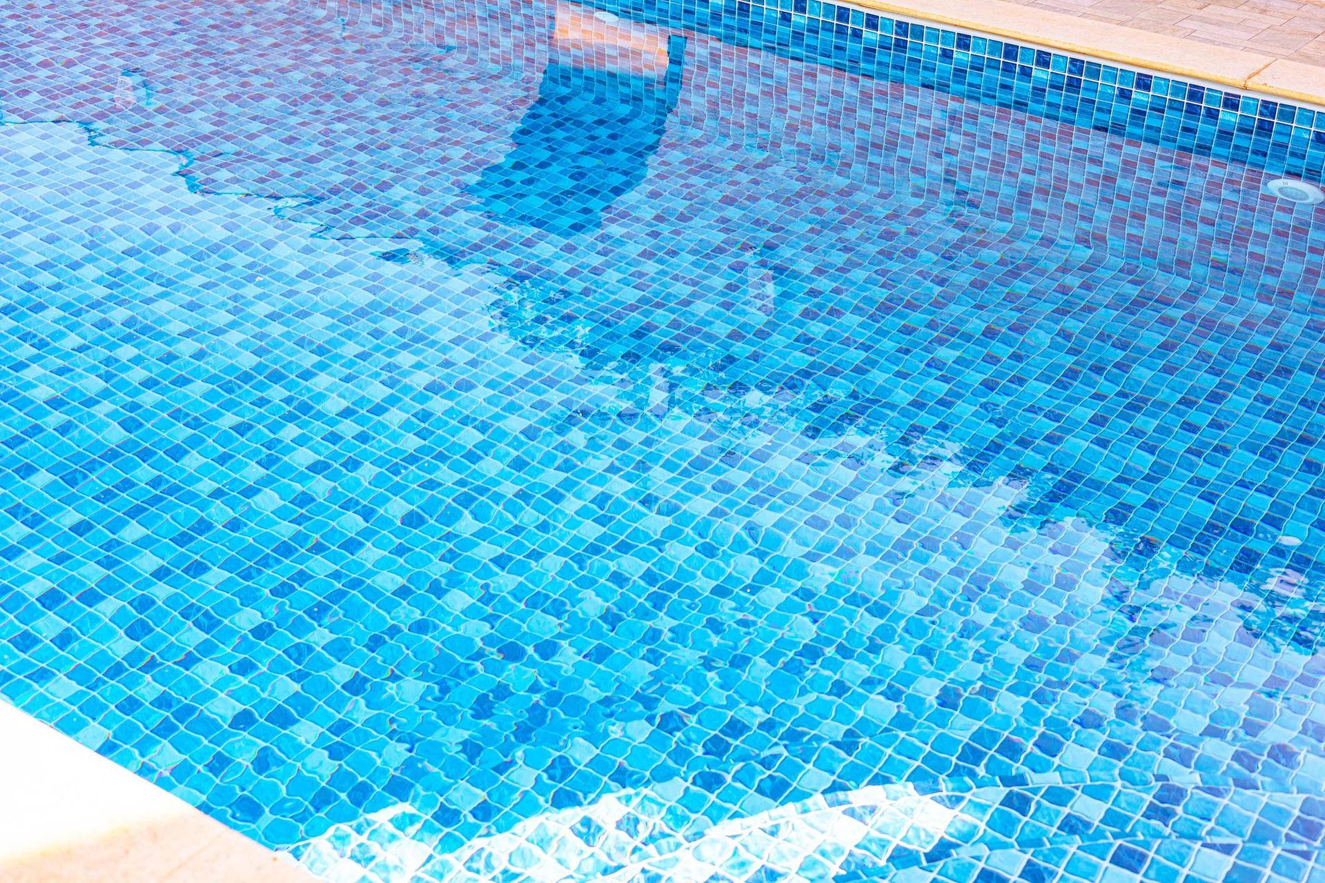 Blue tiled swimming pool reflecting sky. Blue tiled swimming pool reflecting sky.