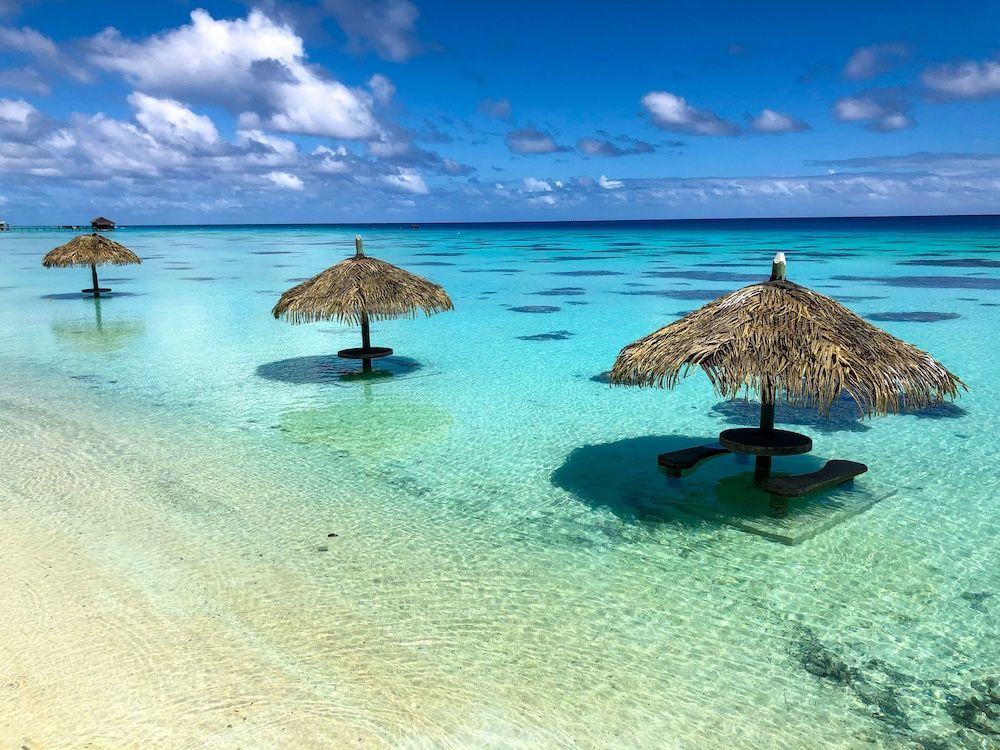 relax under the shade of an overwater umbrella, in Fiji