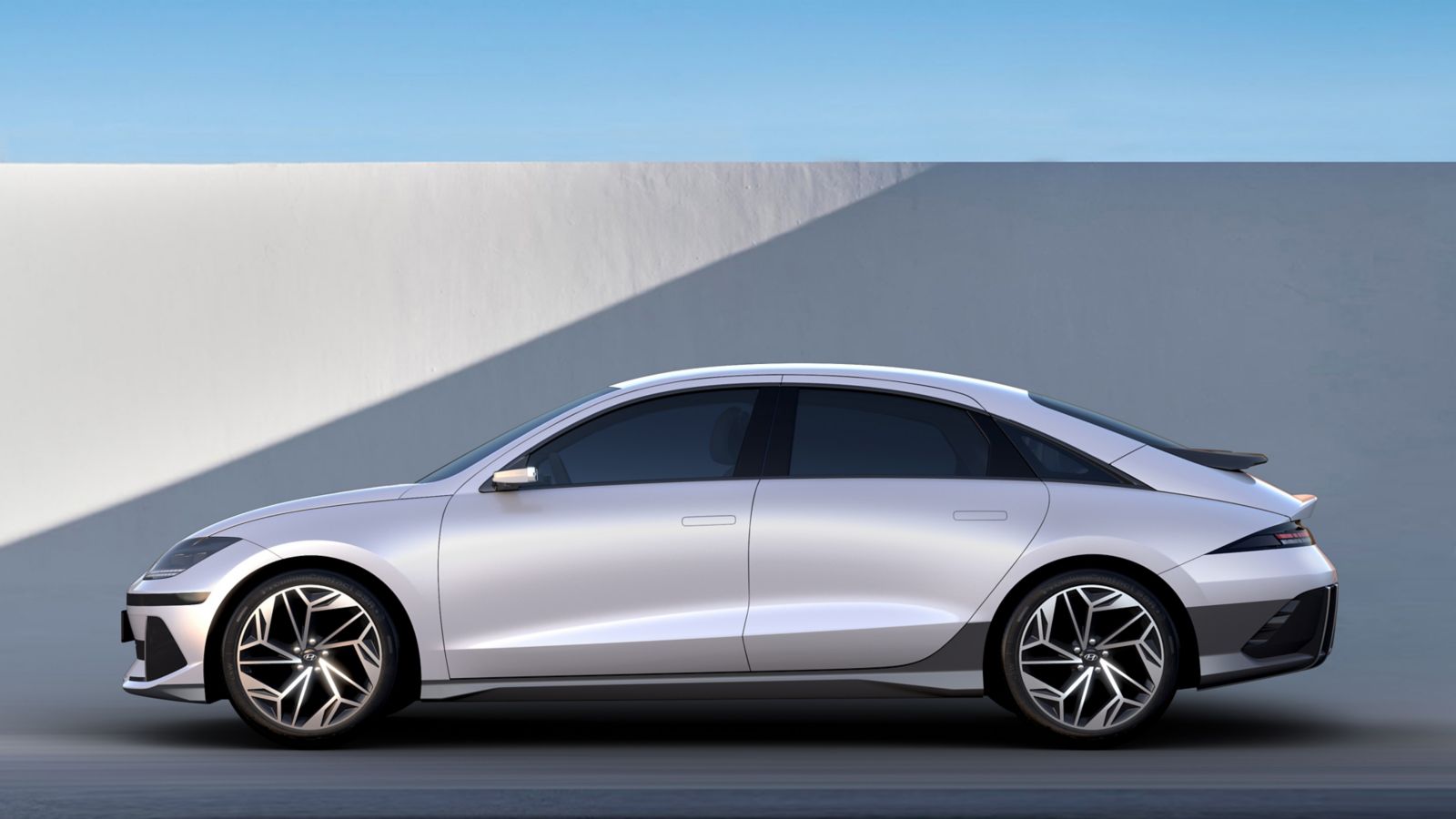 A white car is parked on the side of a road. Ioniq 6
