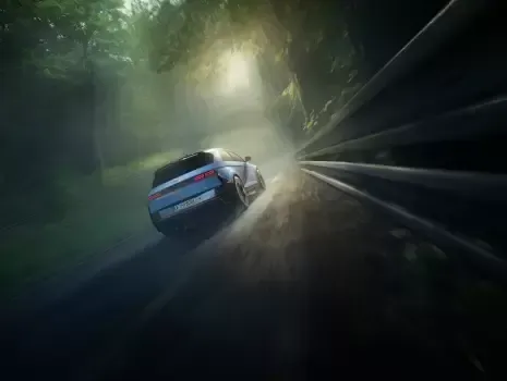 A car is driving down a road in the fog. Ioniq 5