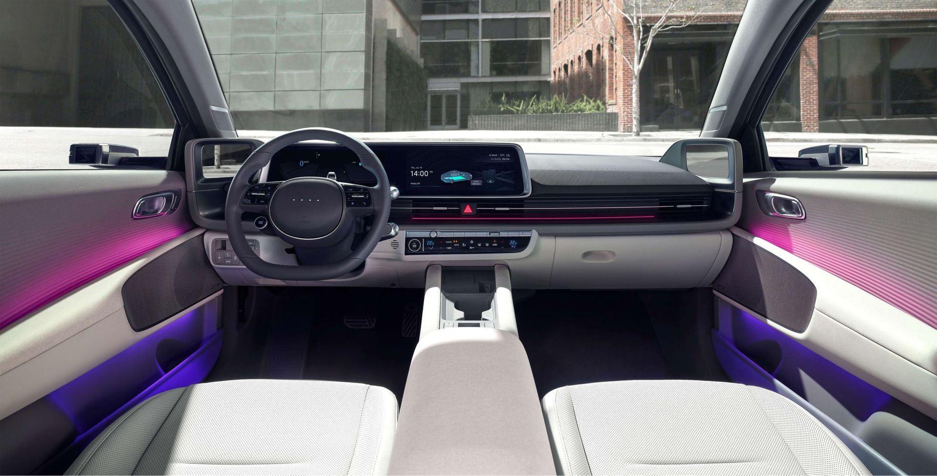 The interior of a car with a steering wheel and purple lights. Ioniq 6