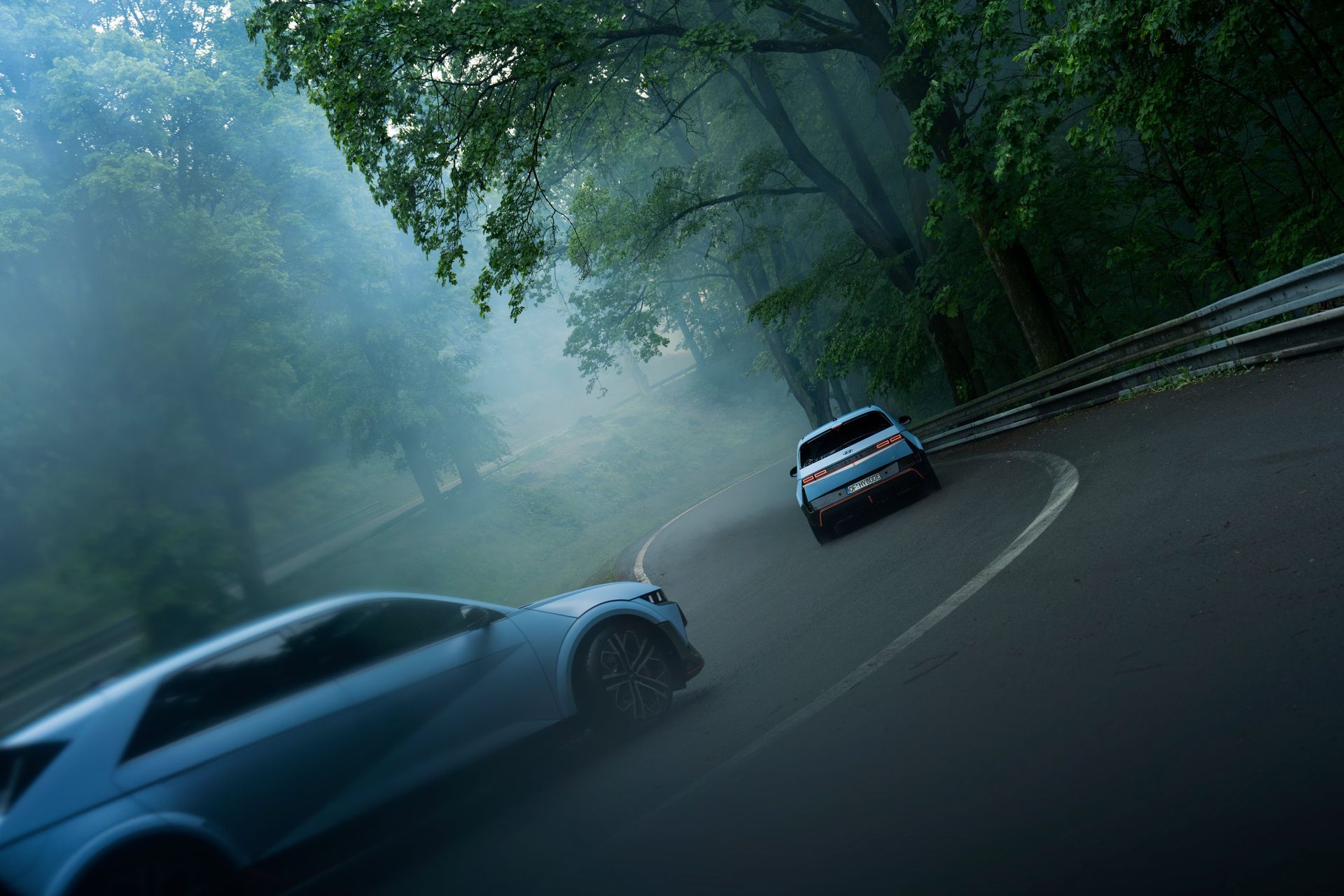 Two cars are driving down a foggy road. Ioniq 5 N