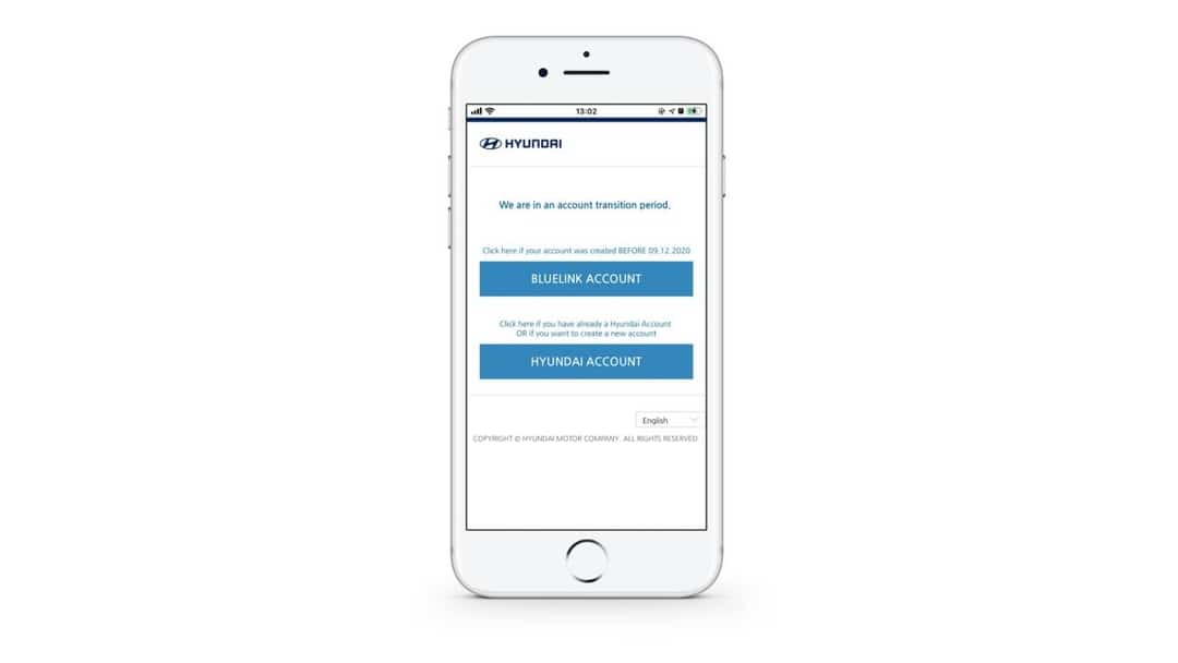 A white cell phone with a blue button on the screen.