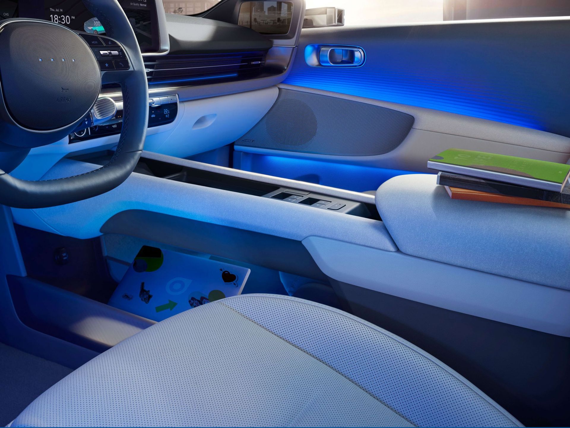 The inside of a car with blue lights on the dashboard Ioniq 6