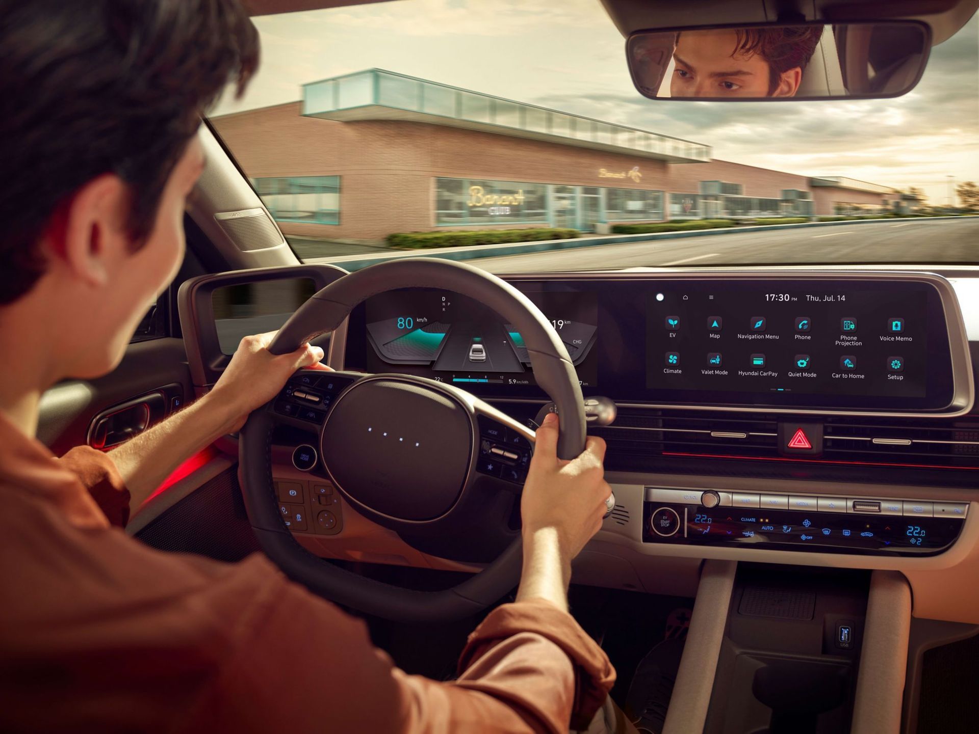 A man is driving a car and looking at the dashboard. Ioniq 6