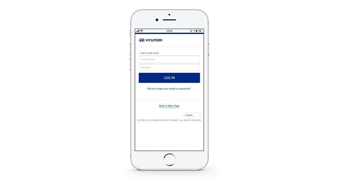 A white cell phone with a login page on the screen.