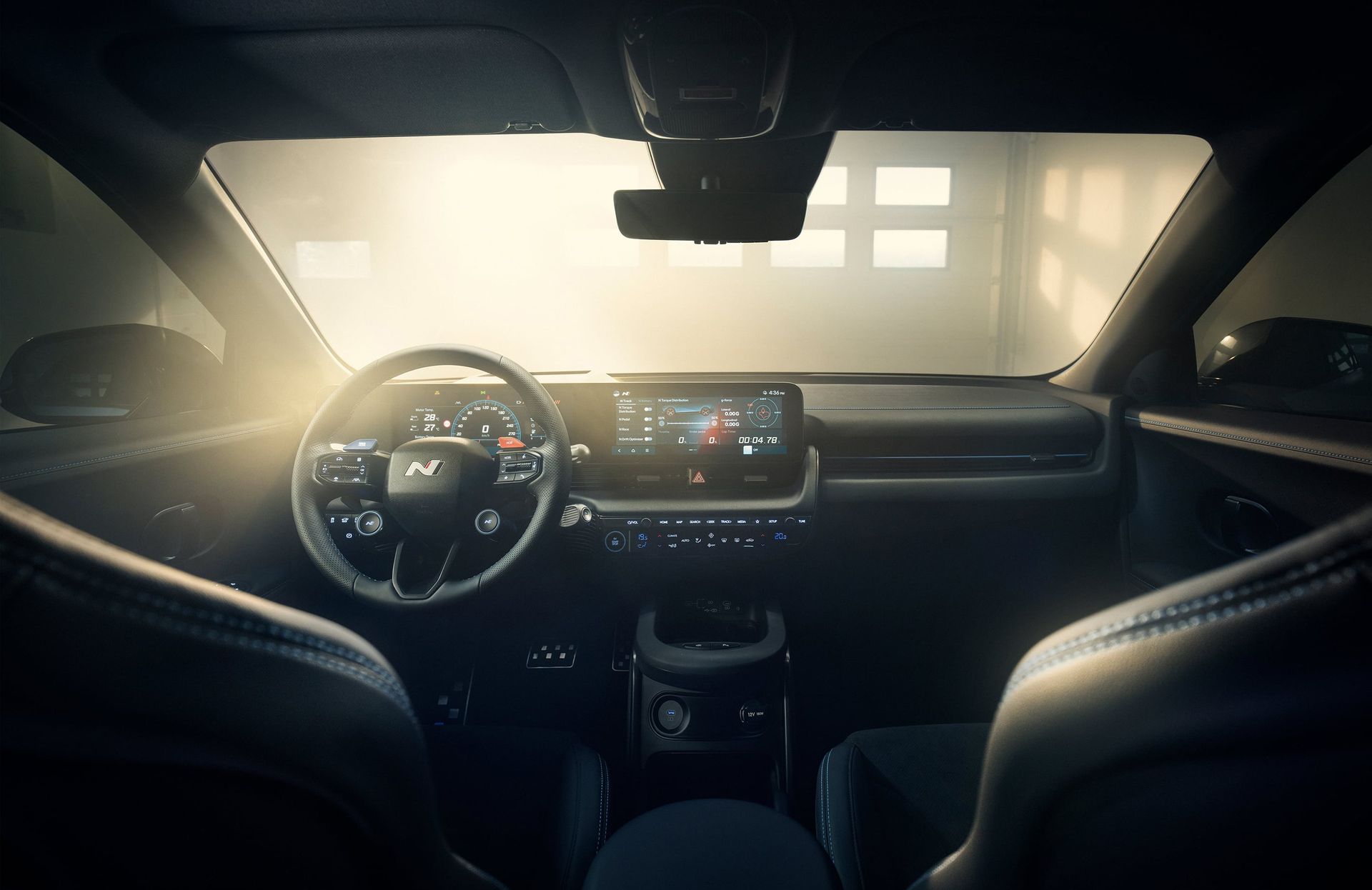 The inside of a car with the sun shining through the windshield. Ioniq 5 N