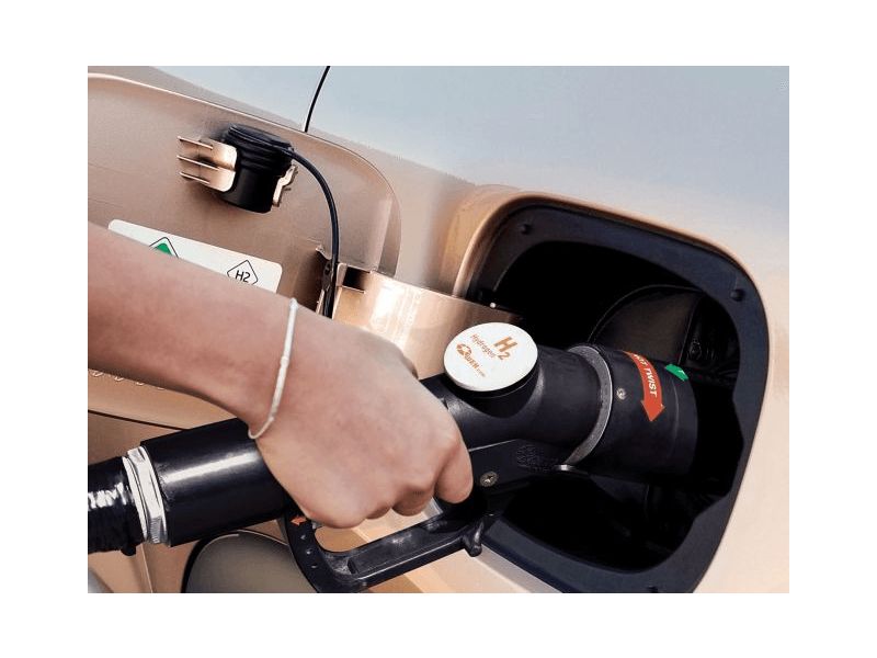 A person is pumping gas into a car.