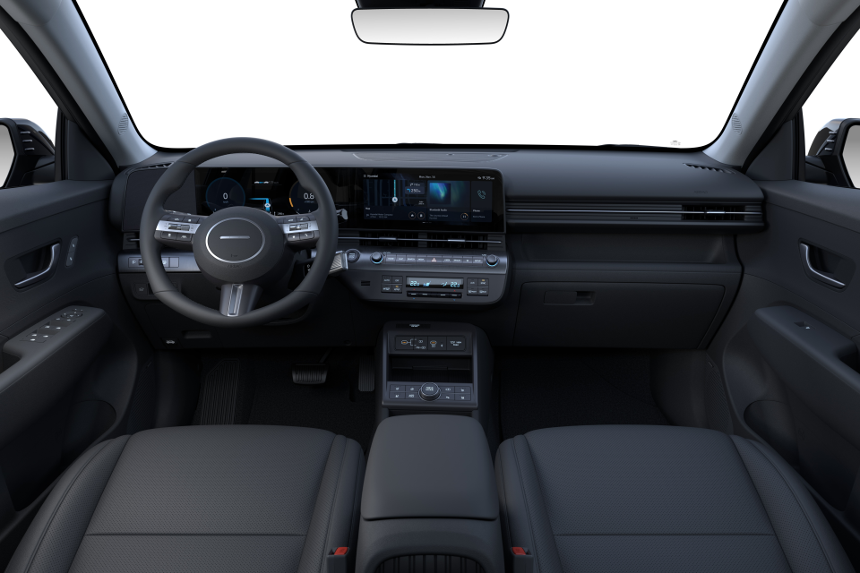 The interior of a car with a steering wheel and dashboard. Kona