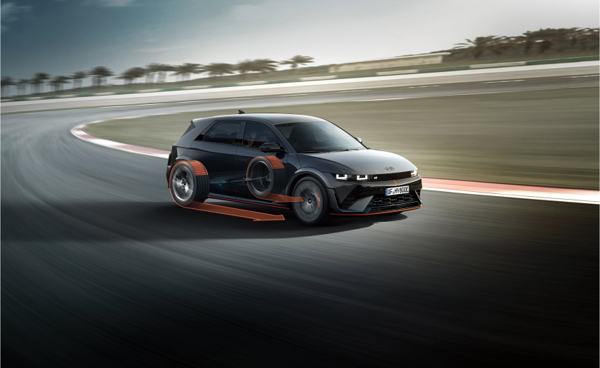 A black car is driving on a race track. Ioniq 5 N