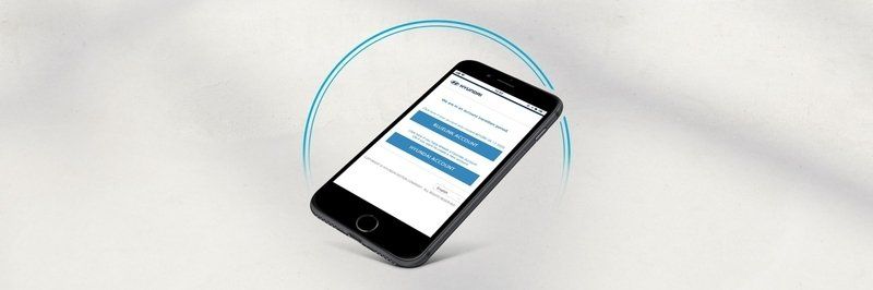 A cell phone is floating in the air on a white surface.