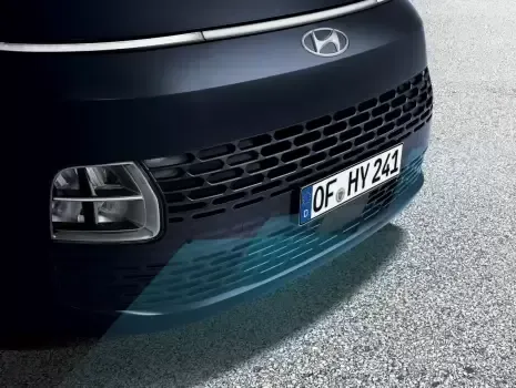 A close up of the front bumper of a hyundai Staria.