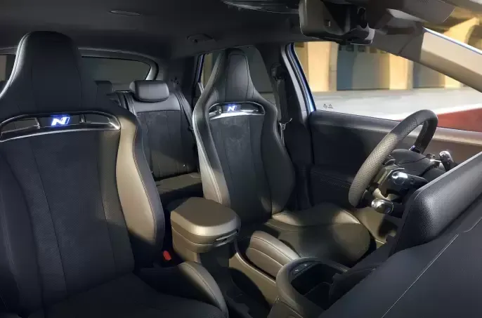 The interior of a car with a steering wheel and seats. Ioniq 5 N